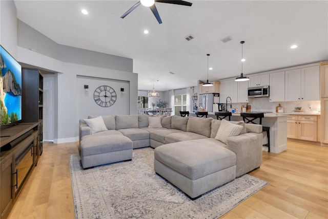 living area featuring recessed lighting, visible vents, and light wood finished floors