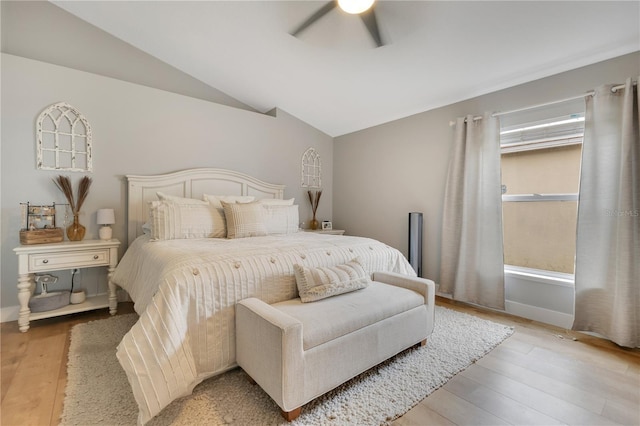 bedroom featuring lofted ceiling, baseboards, a ceiling fan, and wood finished floors