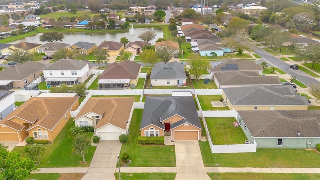 birds eye view of property featuring a water view and a residential view