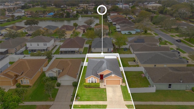 birds eye view of property featuring a water view and a residential view