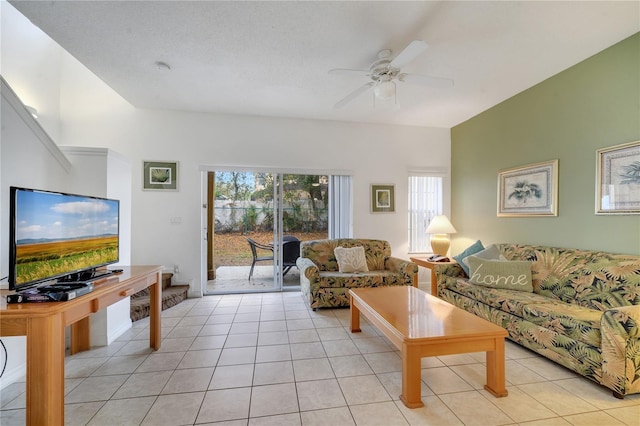 living room featuring light tile patterned floors, a ceiling fan, and a wealth of natural light