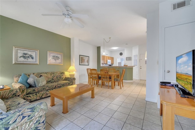 living area featuring visible vents, ceiling fan, baseboards, and light tile patterned floors