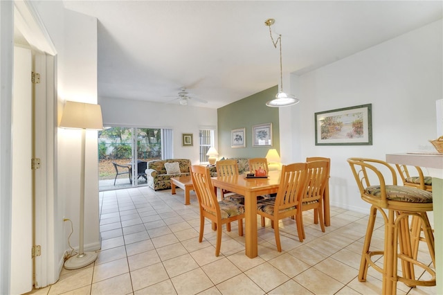 dining space featuring ceiling fan, baseboards, and light tile patterned flooring