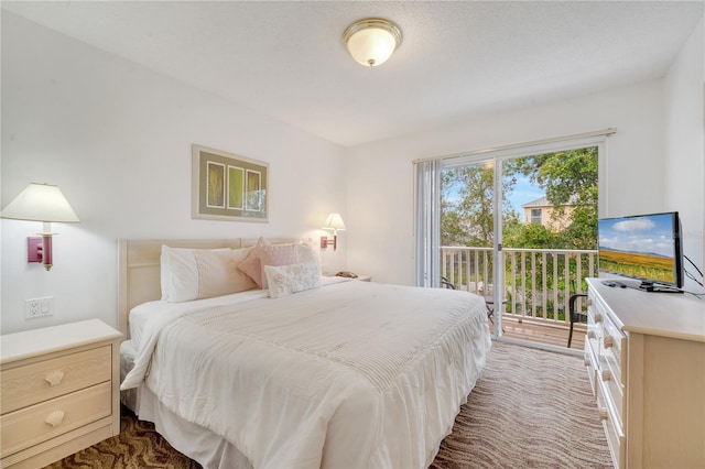 bedroom with access to exterior and dark carpet