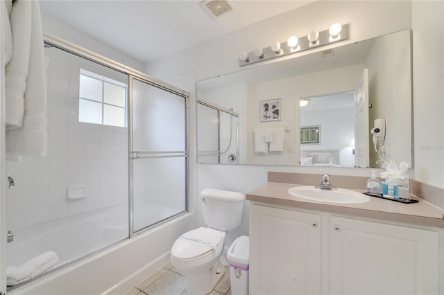 full bath featuring visible vents, toilet, tile patterned flooring, combined bath / shower with glass door, and vanity