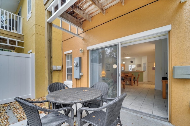 view of patio with outdoor dining space and fence