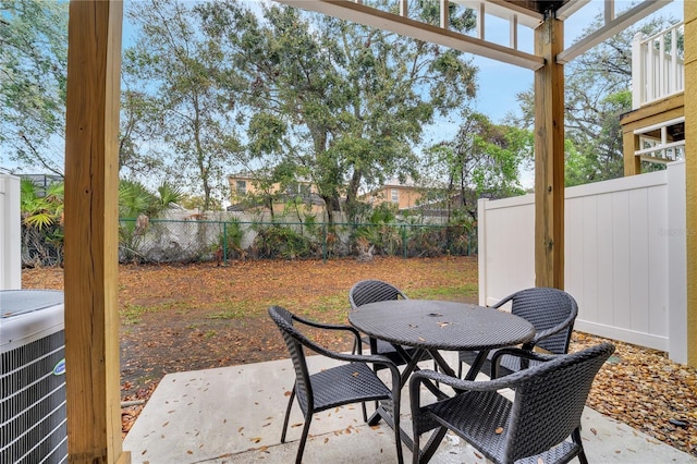 view of patio / terrace featuring outdoor dining space, central AC, and a fenced backyard