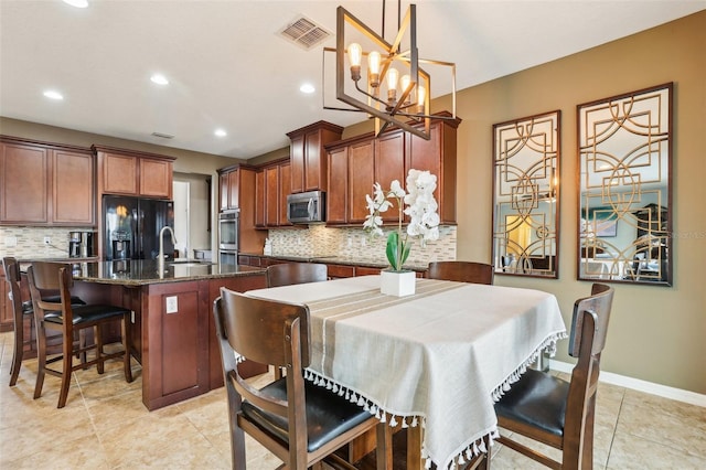 dining space with light tile patterned floors, recessed lighting, visible vents, and baseboards