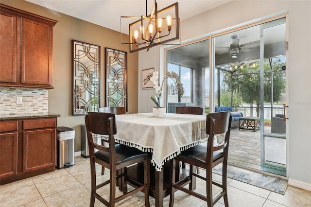 dining space featuring ceiling fan, baseboards, and light tile patterned floors