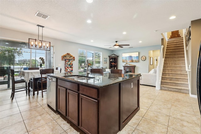 kitchen featuring visible vents, a sink, stainless steel dishwasher, and light tile patterned floors