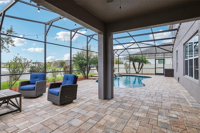 view of pool with a fenced in pool, glass enclosure, a patio area, ceiling fan, and fence