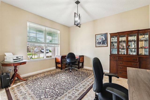 home office with an inviting chandelier and baseboards