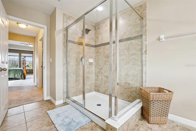 full bathroom featuring a stall shower, baseboards, and ensuite bath