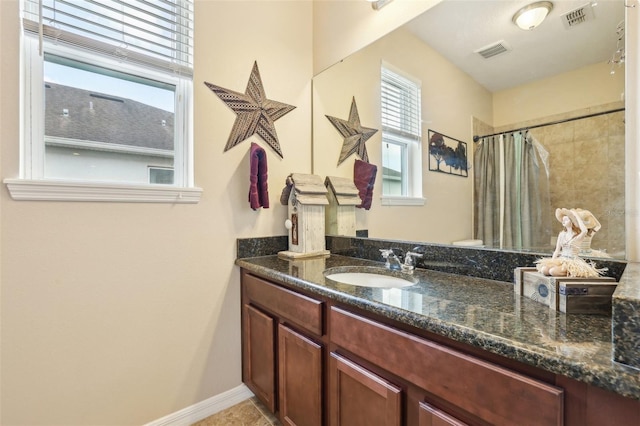 bathroom with a shower with shower curtain, tile patterned floors, visible vents, and vanity