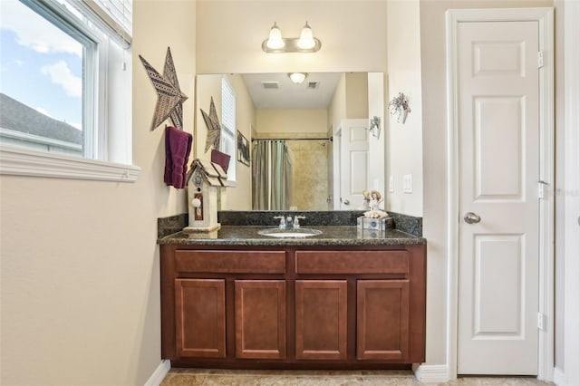 full bath with a shower with curtain, visible vents, and vanity