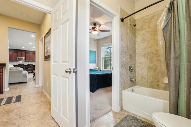 ensuite bathroom featuring ceiling fan, tile patterned flooring, connected bathroom, toilet, and shower / tub combo with curtain