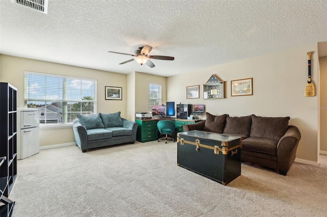 living room featuring baseboards, ceiling fan, visible vents, and carpet flooring