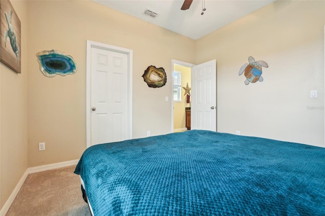 carpeted bedroom with baseboards, visible vents, and a ceiling fan