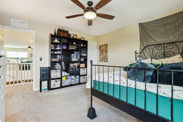 carpeted bedroom featuring visible vents