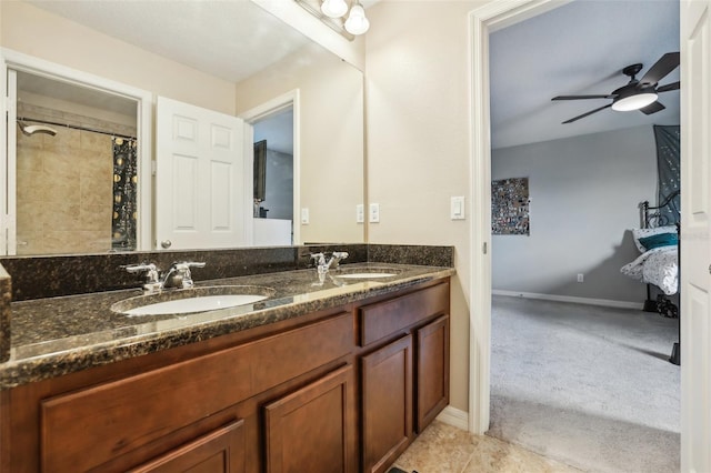 full bath featuring double vanity, a sink, baseboards, and ceiling fan