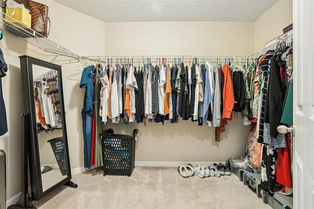 spacious closet with carpet flooring