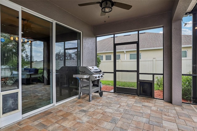 unfurnished sunroom with a ceiling fan