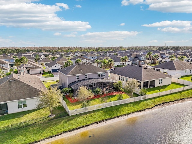 birds eye view of property featuring a water view and a residential view