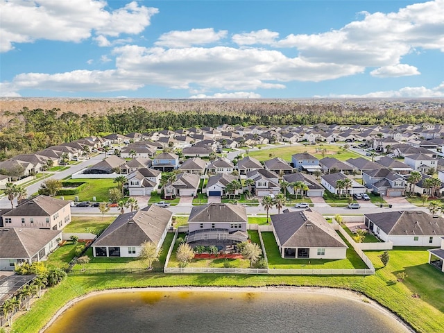 bird's eye view featuring a water view and a residential view