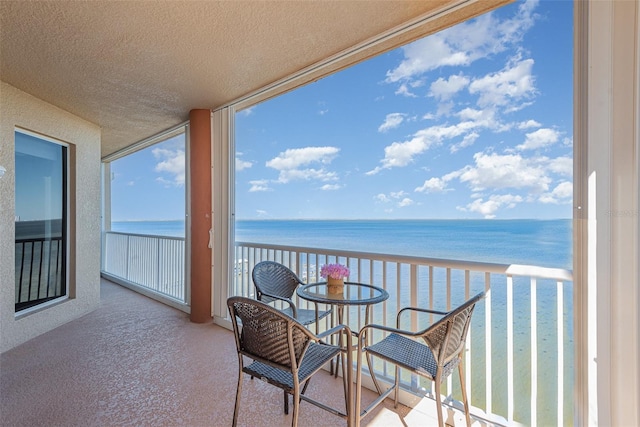 balcony featuring a water view