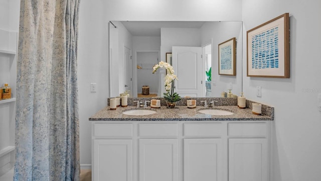 full bathroom with a sink and double vanity