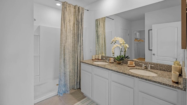 full bathroom with tile patterned flooring, a sink, a shower with curtain, and double vanity