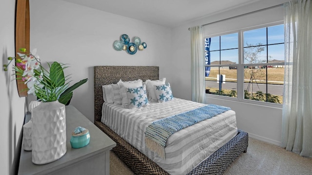 carpeted bedroom featuring baseboards