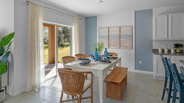 dining room with baseboards and light tile patterned flooring