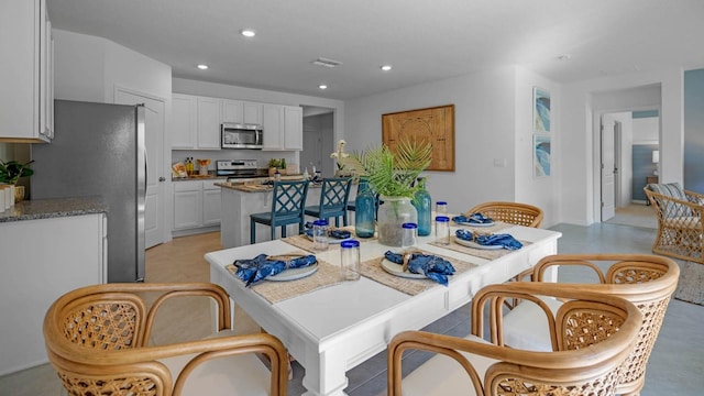 dining space featuring recessed lighting