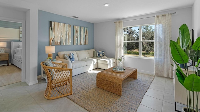 tiled living area featuring visible vents and baseboards