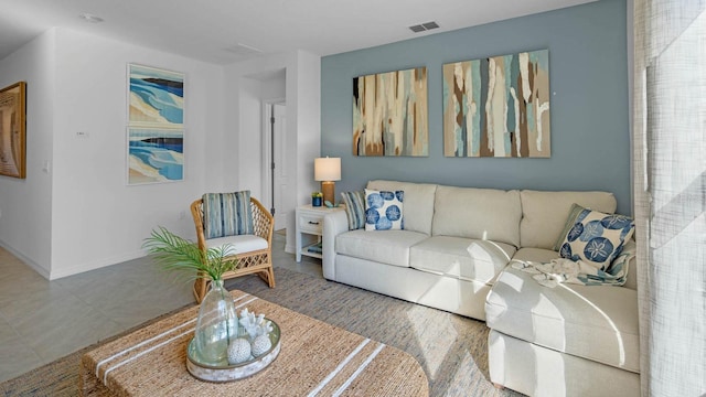 living room featuring baseboards and visible vents