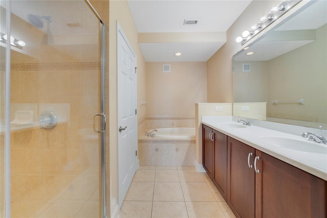 bathroom with a bath, a stall shower, a sink, and tile patterned floors