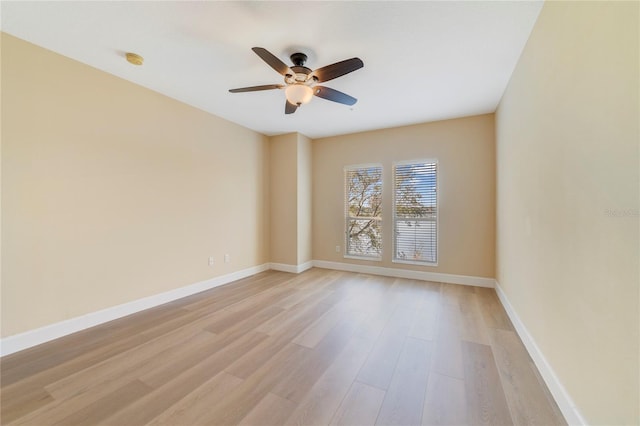 empty room featuring light wood-style floors, baseboards, and a ceiling fan