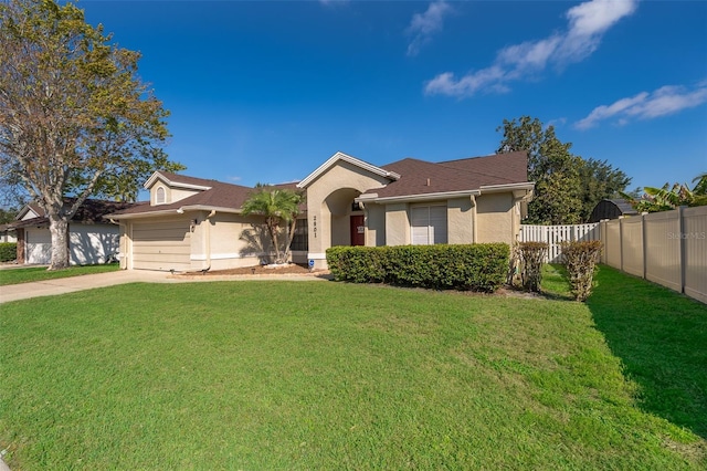 ranch-style house featuring fence, a front lawn, and stucco siding