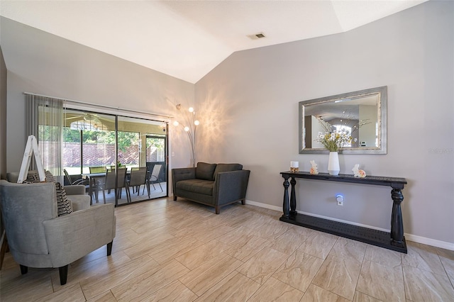 interior space with visible vents, vaulted ceiling, and baseboards