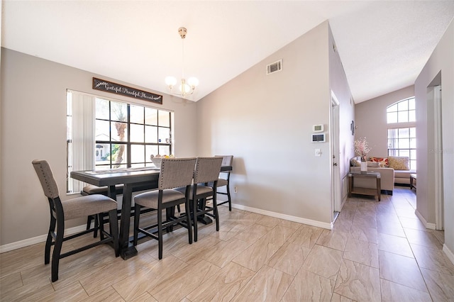 dining room with an inviting chandelier, baseboards, visible vents, and vaulted ceiling