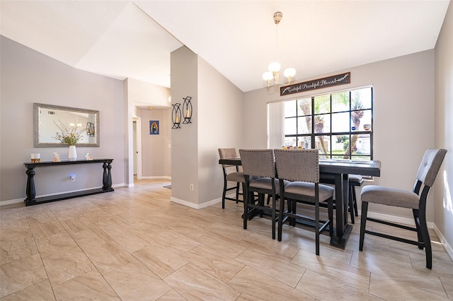 dining room featuring vaulted ceiling, a notable chandelier, and baseboards