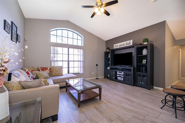 living room with light wood-type flooring, baseboards, vaulted ceiling, and a ceiling fan