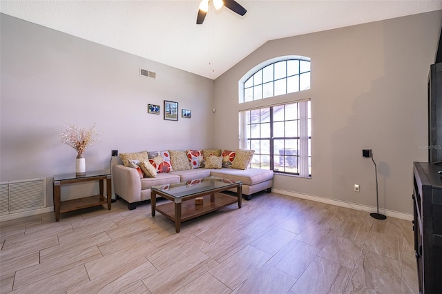 living area featuring high vaulted ceiling, ceiling fan, visible vents, and baseboards