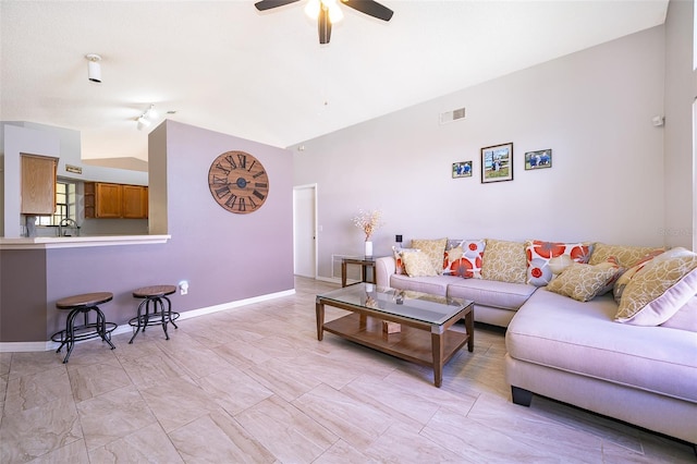 living area with visible vents, vaulted ceiling, baseboards, and ceiling fan