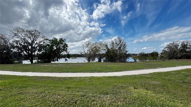 surrounding community with a yard and a water view