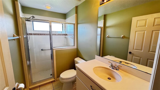 bathroom with toilet, tile patterned flooring, a textured ceiling, vanity, and a shower stall