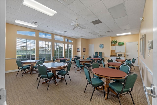 27307 Pine Straw Rd, Leesburg, FL 34748 - dining area featuring light carpet, visible vents, a paneled ceiling, and ceiling fan