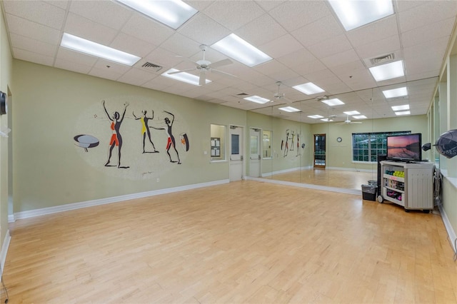 27307 Pine Straw Rd, Leesburg, FL 34748 - workout room with visible vents, baseboards, ceiling fan, and wood finished floors