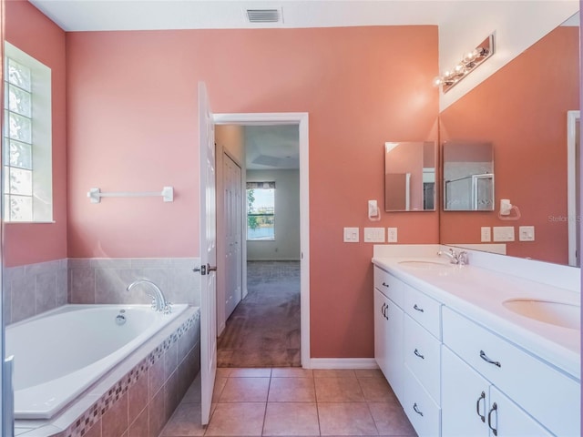 27307 Pine Straw Rd, Leesburg, FL 34748 - bathroom with a sink, visible vents, a garden tub, and tile patterned flooring